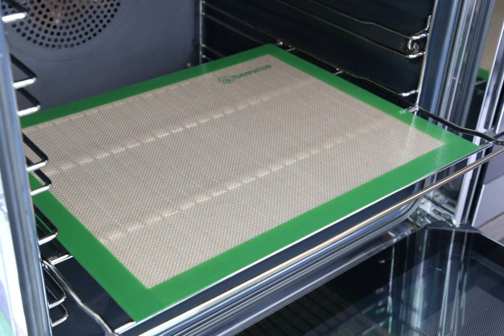 Leafera - Silicone baking mat with green border on an oven rack