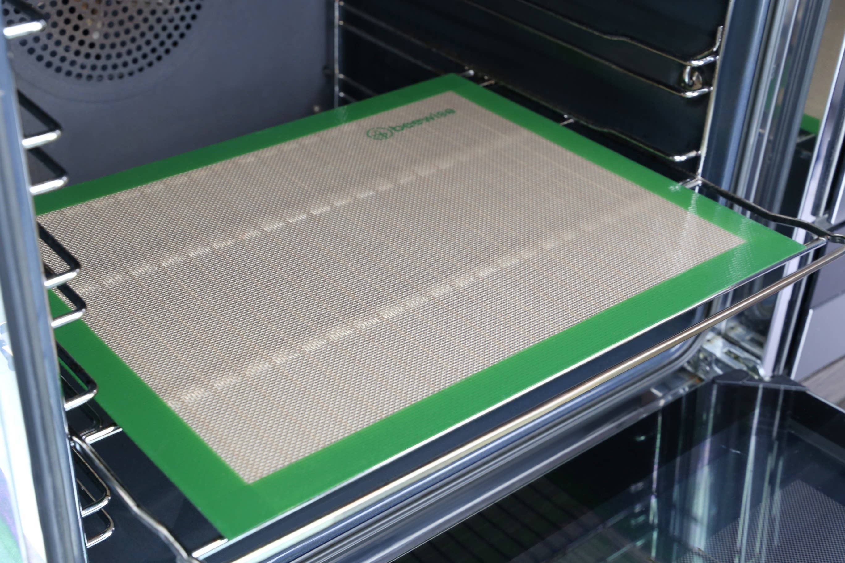 Leafera - Silicone baking mat with green border on an oven rack