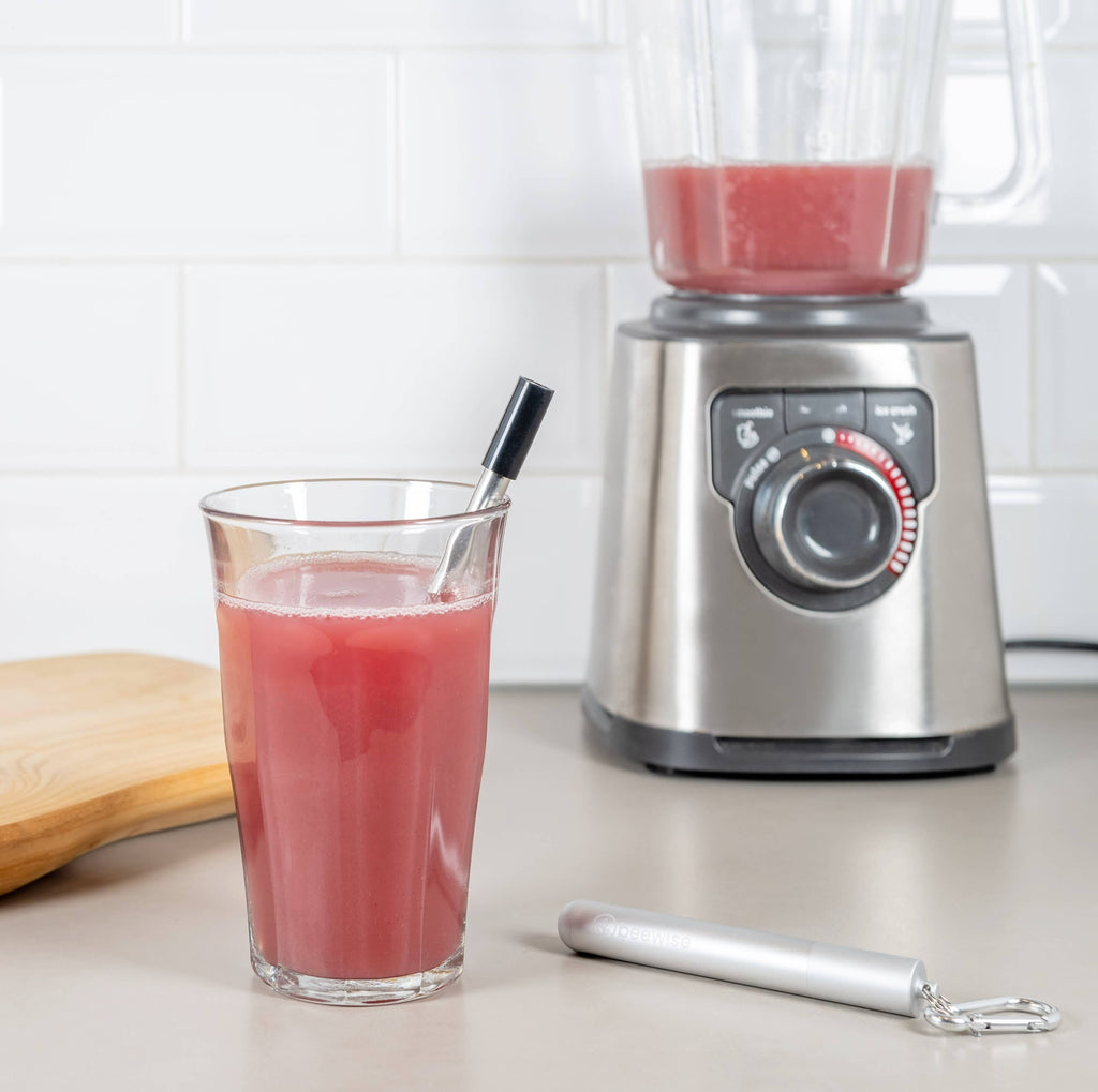 Leafera - Blender with pink juice and a glass of pink juice on a countertop.